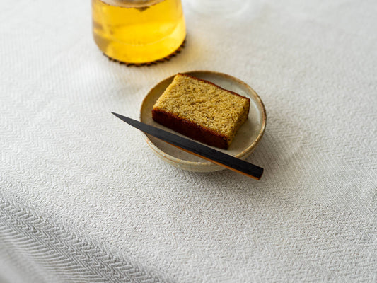 Smoked bamboo confectionery knife on a small dish / 炭竹の菓子切りが小皿の上に置かれている様子