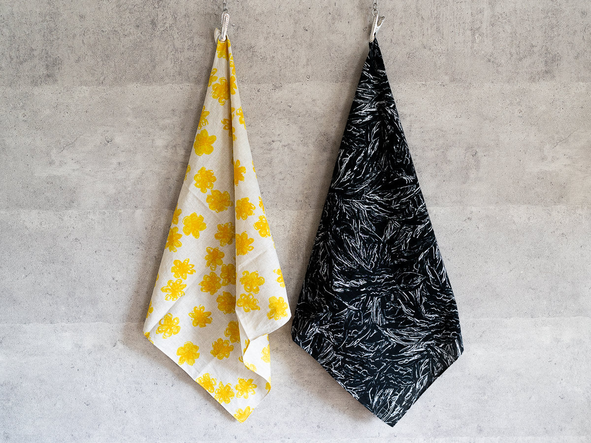 Khadi cotton bandanas in two designs hung on a wall / カディコットンのバンダナを壁に掛けた様子